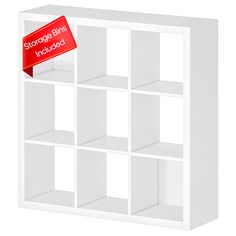 a white bookcase with several shelves and a red sticker on the top that says storage bins included