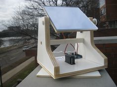 a solar powered device sitting on top of a roof