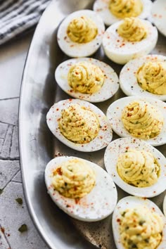 deviled eggs with mustard and seasoning in a pan