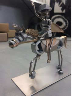 a metal sculpture of a person riding a horse