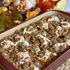 a casserole dish with marshmallows and other toppings in it