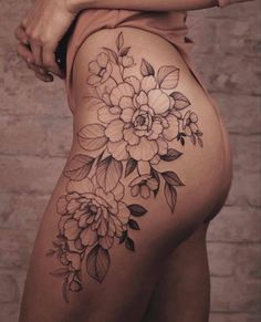 a woman's thigh with flowers on it