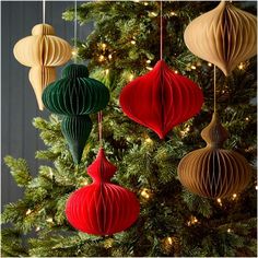 christmas ornaments hanging from a tree with lights