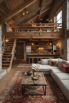 a living room filled with furniture next to a stair case in a loft style home