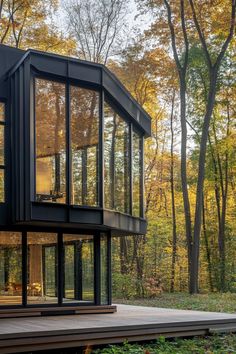 a modern house in the woods surrounded by trees