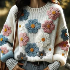 a close up of a person wearing a sweater with flowers on the front and back