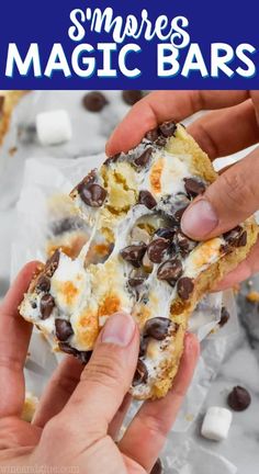 two hands holding a cookie bar with chocolate chips and marshmallows