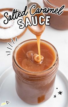 salted caramel sauce is being poured into a glass jar on a white plate