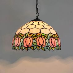 a stained glass light hanging from a chain