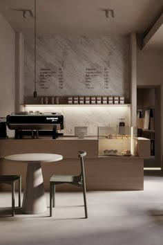 the interior of a coffee shop with tables and chairs