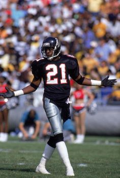 a football player holding his arms out on the field