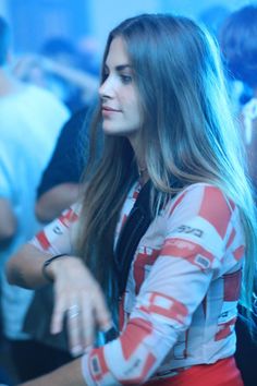 a woman with long hair is sitting down