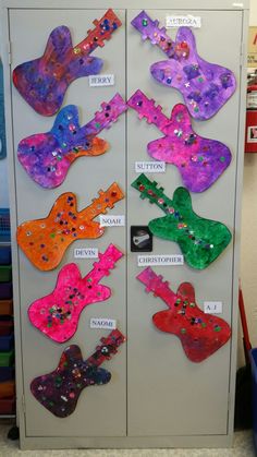 a locker with many different colored guitars on it