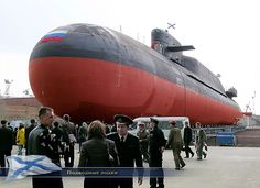 people are standing in front of a large boat