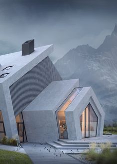 an unusual house in the mountains with stairs leading up to it's roof and windows