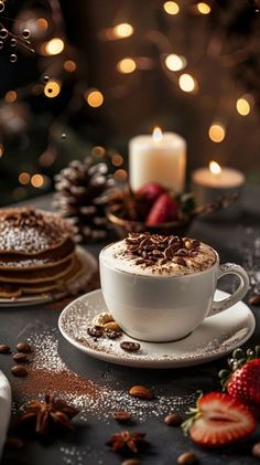 there is a cup of hot chocolate on the table with strawberries and cookies around it