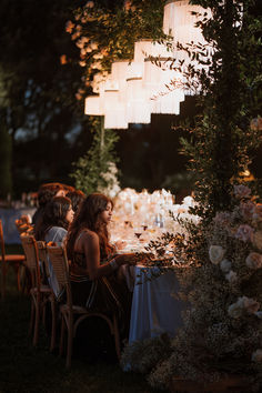 two women sitting at a dinner table in the evening