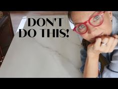 a woman wearing glasses sitting in front of an open suitcase with the words don't do this