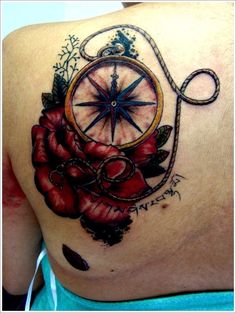 a woman with a compass and roses tattoo on her back