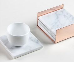 two marble coasters and a cup sitting on top of each other