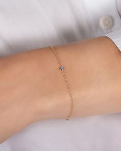 Beautifully handcrafted birthstone of your choice in a 14k yellow gold small mini bezel cup laying on a dainty cable link chain bracelet. Uber chic and timeless bracelet, perfect by itself or stacked. Total Weight: Approx. 0.7 grams Size of Mini Bezel Birthstone: Approx. 3mm Birthstone Bezel Carat Weight: Approx. 0.03 ctw Available Birthstones: Garnet, Amethyst, Aquamarine, Diamond, Emerald, Alexandrite, Ruby, Peridot, Sapphire, Rose Zircon, Topaz, Blue Zircon Standard Production: 5-8 business d Aquamarine Gold Bracelet, Birthstone Bracelet For Mom, Dainty 14k Gold Birthstone Chain Bracelet, 14k Gold Chain Bracelet With Bezel Setting As Gift, 14k Gold Chain Bracelet With Bezel Setting, Dainty Yellow Gold Chain Bracelet With Birthstone, Dainty Chain Bracelet With Bezel Setting As Gift, Dainty 14k Gold Birthstone Bracelets, Dainty 14k Gold Gemstone Chain Bracelet