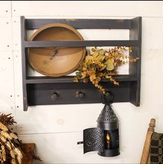 a shelf that has some plants on it and a potted plant next to it