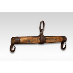 an old wooden coat rack with two hooks