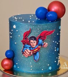 there is a superman cake on the table