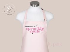 a pink apron with the words, the future is sparkly nails printed on it