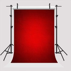 a red backdrop with two black stands