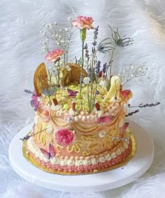 there is a cake with flowers on the top and butterflies on the bottom that are all over it