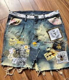 a pair of jean shorts with patches on them