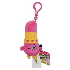 a pink stuffed animal with a yellow hat on it's head and tongue sticking out