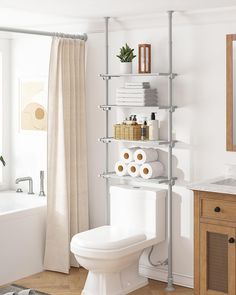 a white toilet sitting next to a bathroom sink