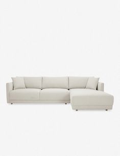 a white sectional couch sitting on top of a white floor