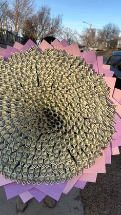 there is a large flower made out of cans