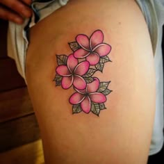 a woman's thigh with pink flowers on it