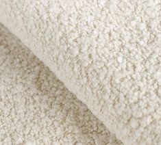 a close up view of a white blanket that is made out of thick, fluffy wool