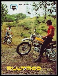 two men on motorcycles in the dirt near trees