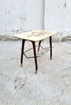 a small table sitting on top of a cement floor