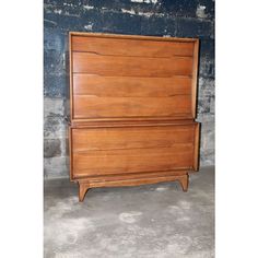 an old wooden dresser sitting in front of a brick wall