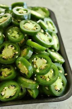 green bell peppers are in a black tray