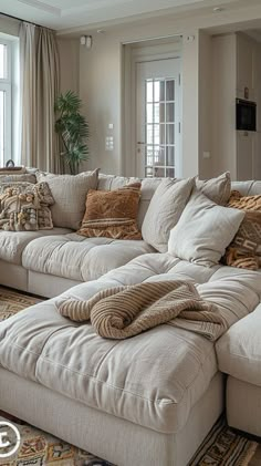 a living room filled with lots of furniture next to a large open window on top of a carpeted floor