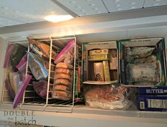 an open refrigerator filled with lots of food and packaged items in it's shelves