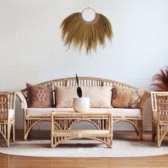 a living room with wicker furniture and plants