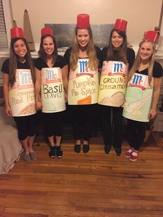 four girls wearing funny hats and holding up signs