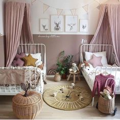 two twin beds in a bedroom with pink curtains and white bedding on the walls