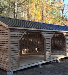 a small wooden shelter in the woods