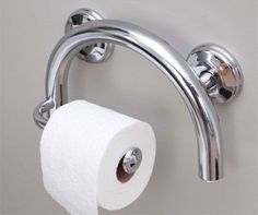 two rolls of toilet paper are hanging from the handle of a bathroom faucet