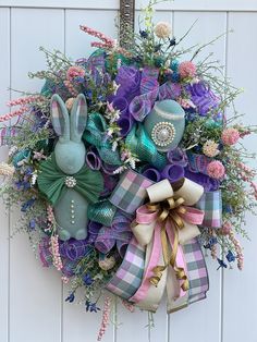 a wreath decorated with purple, blue and green decorations